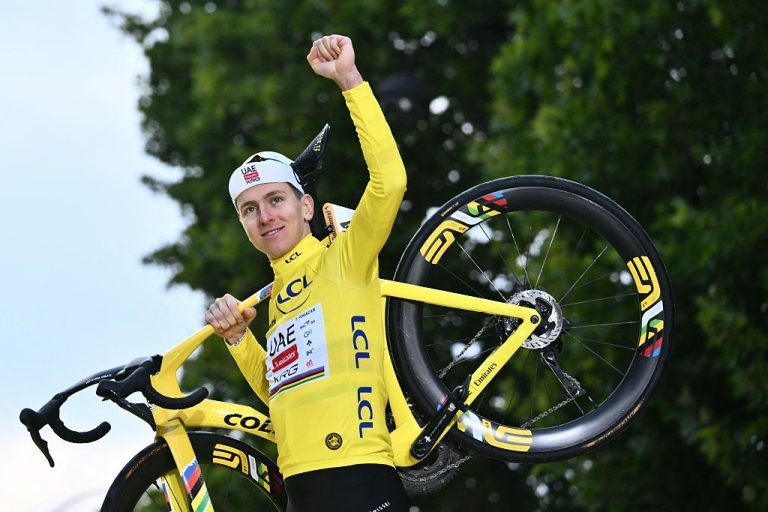 TOPSHOT - UAE Team Emirates - XRG team's Slovenian rider Tadej Pogacar celebrates on the podium with the overall leader's yellow jersey after the 21st and final stage of the 112th edition of the Tour de France cycling race, 132.3 km between Mantes-la-Ville and Paris Champs-Élysees, on July 27, 2025. (Photo by Marco BERTORELLO / AFP) (Photo by MARCO BERTORELLO/AFP via Getty Images)